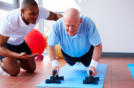 Senior Doing Push-Ups with His Trainer