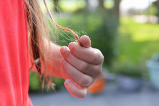 Girl touching her hair on the street 