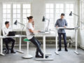 people are working at the standing desks