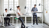 people are working at the standing desks