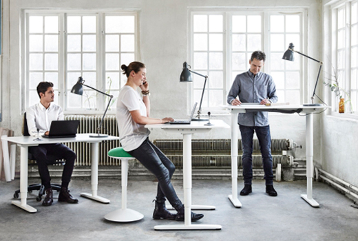 people are working at the standing desks