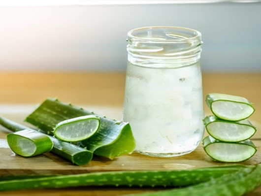 Aloe vera leaves and aloe vera gel are on the wooden background 
