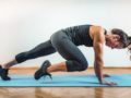 Fit and strong girl exercising on the green mat