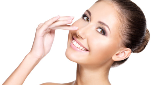 Beautiful girl on white background with a beautiful and even nose