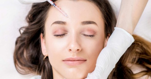 Girl is doing injectable to her forehead