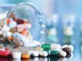 Colourful capsules and pills are scattered on the table