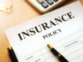 Insurance policy paper on wooden table