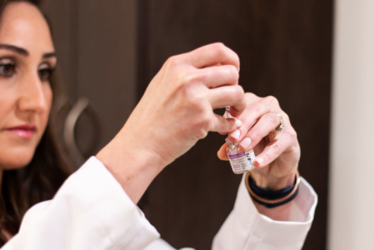 Doctor is holding botulinum solution in hands before doing the injection