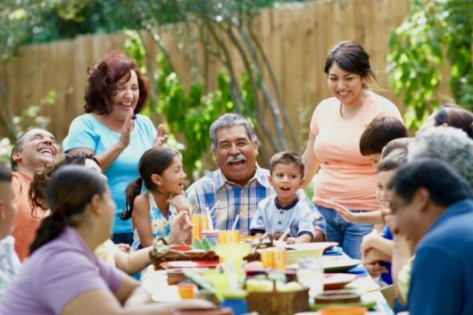 A happy family at the table is smiling and communicating. 