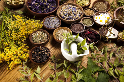 Different herbs on wooden table