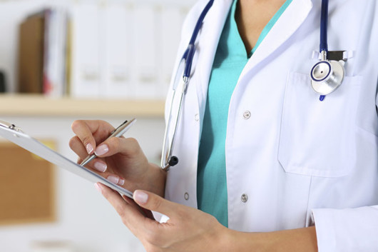 Female medicine doctor hand holding silver pen writing something on clipboard closeup. Medical care, insurance, prescription, paper work or career concept. Physician ready to examine patient and help