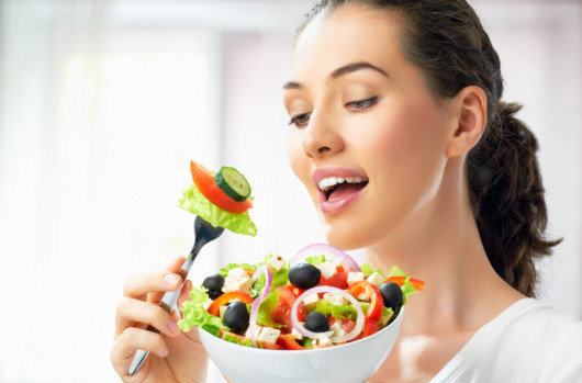 Girl with a big bowl of salad. Girl is on a diet and planing to eat the salad