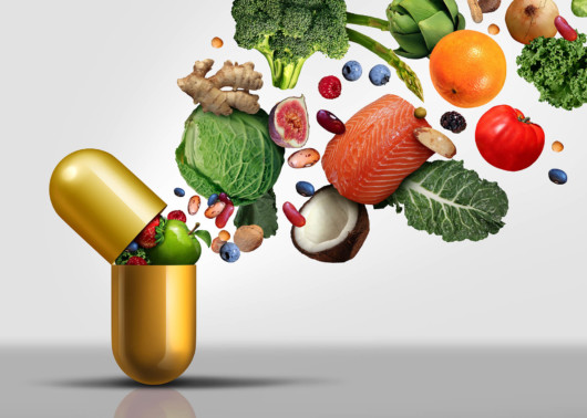 Vitamins supplements as a capsule with fruit vegetables nuts and beans inside