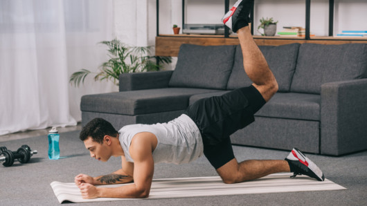 Guy is exercising at home to build muscles