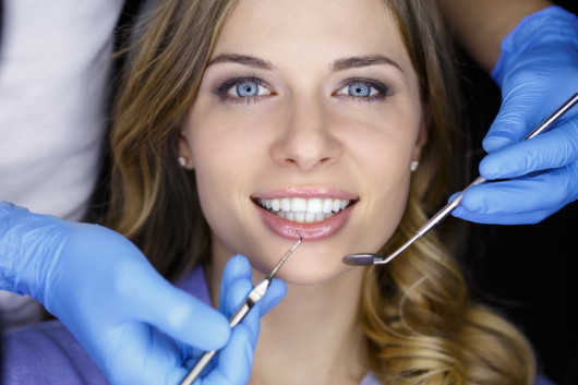 Dentist examining a patient teeth in the dentist.