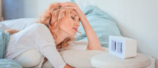 Girl with insomnia is lying in bed and trying to fall asleep