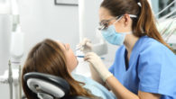 Dentist examining patient's teeth