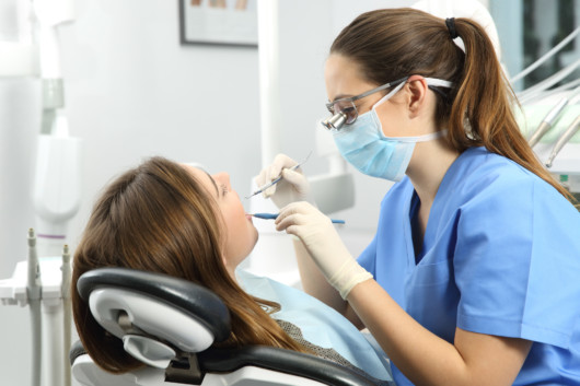 Dentist examining patient's teeth