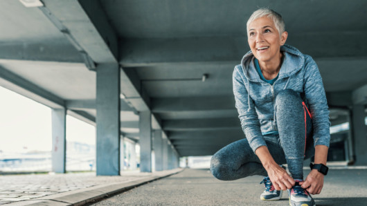 A middle age woman is exercising outside