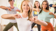 a group of young people are happily dancing and exercising