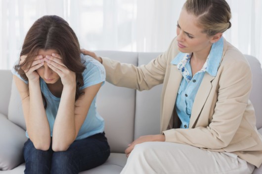 The woman is talking to a drug addict girl about her addiction