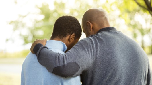 A father in grey sweater and is talking to a drug addict son on the street