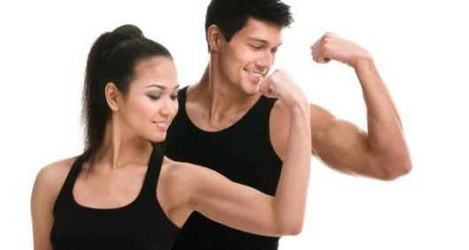 A woman and a man in black undershirt on white background are showing their biceps  