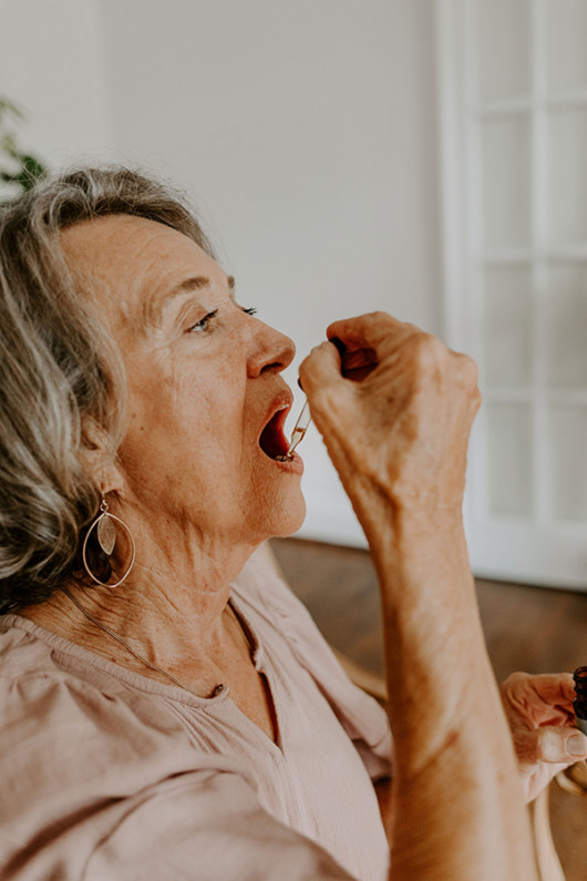 An old lady is taking cannabis oil to prevent menopause