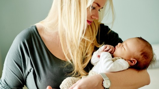 A young mom with a baby in her arms