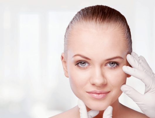 The doctor is checking the girls face after the facelift procedure