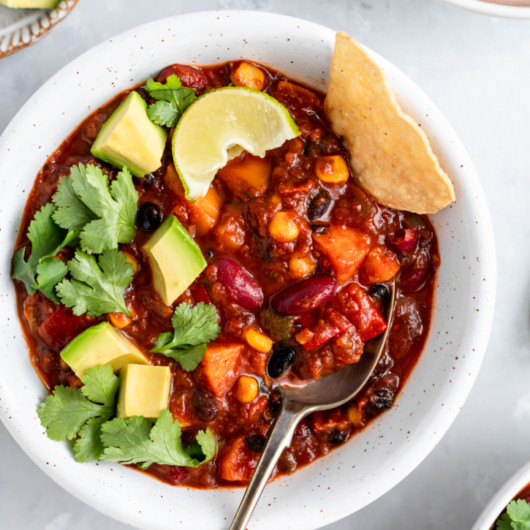 Meat or Veggie Chili in the white plate and on the white table