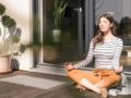 Girl is sitting outside in the sun and meditate