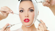 A beautiful girl with red lips and the bandage around her head on the white background