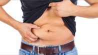 A man in black shirt on white background is showing his big belly and loose skin