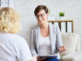 Two girls sitting in the room and discussing different ways of counseling