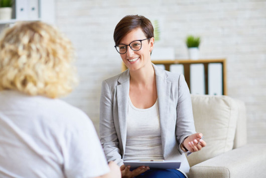 Two girls sitting in the room and discussing different ways of counseling