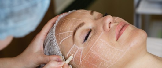 A close up woman's face with marked perforation lines