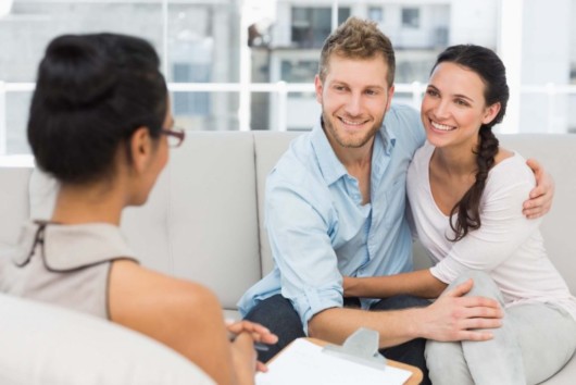 A girl is consulting a young embracing couple