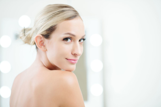 A girl showing her beautiful face and smiling after the peptide therapy