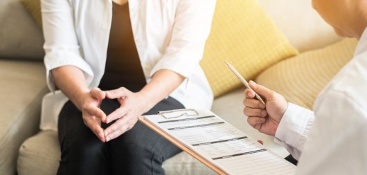 Doctor explaining to the woman the labiaplasty procedure