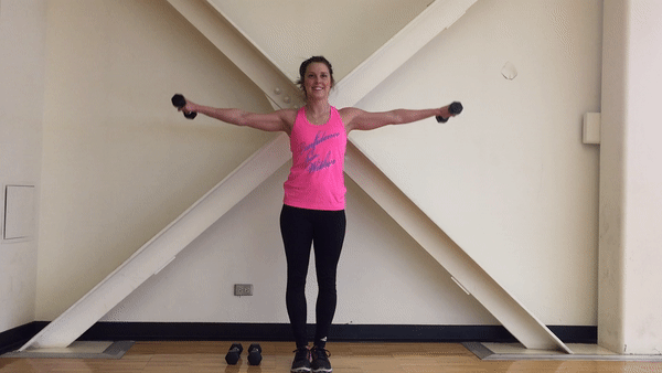 Fit Girl Performs Arm Circles in the Room to build strong and sexy shoulders
