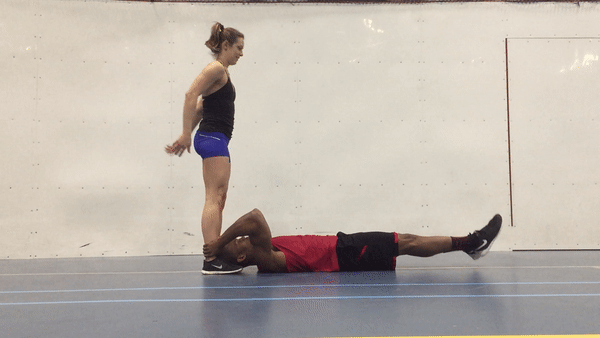 A fit couple is doing centre leg throw down exercise for strong abs and core