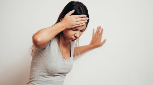 Young girl if holding against the wall because of sudden cardiovascular dizziness