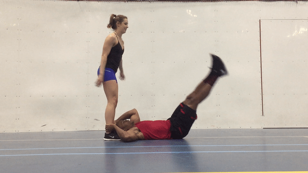 A fit couple is doing side leg throw down exercise for strong abs and core