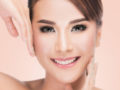 Close up girl's face with ideal and smooth skin on pinky background. Girl after skin rejuvenation treatment