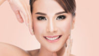 Close up girl's face with ideal and smooth skin on pinky background. Girl after skin rejuvenation treatment