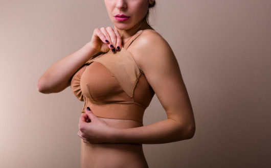 Girl wearing a post operation bra after breast augmentation