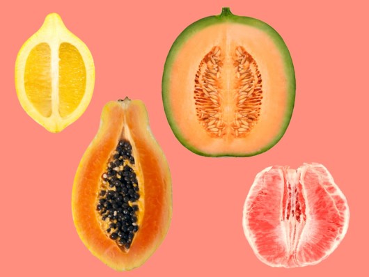 Fruits like lemon, watermelon, papaya and grapefruit on the pinky background