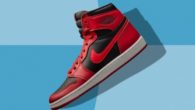 A close up image of red and black Air Jordan 1 sneakers on blue background