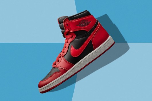 A close up image of red and black Air Jordan 1 sneakers on blue background